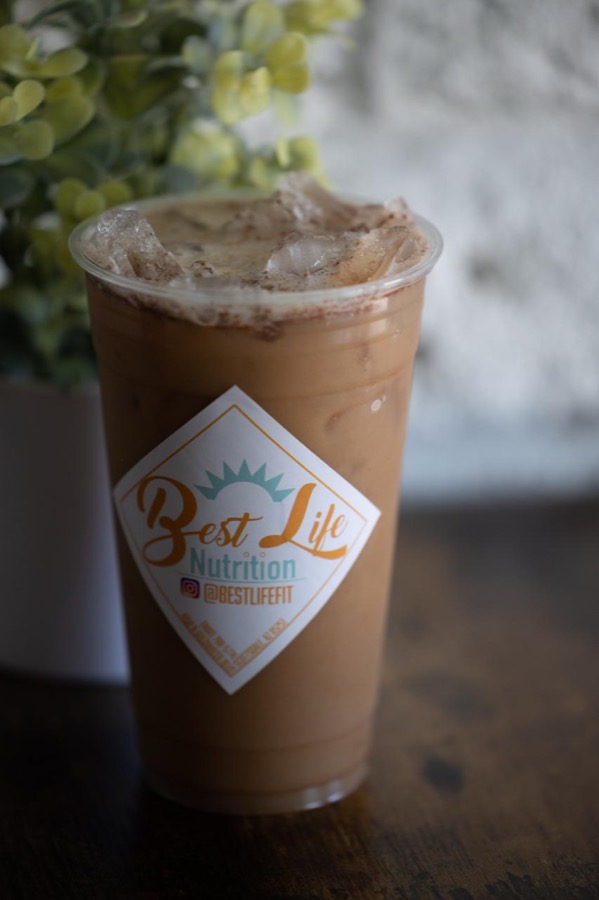 An iced protein coffee in a Best Life Nutrition cup